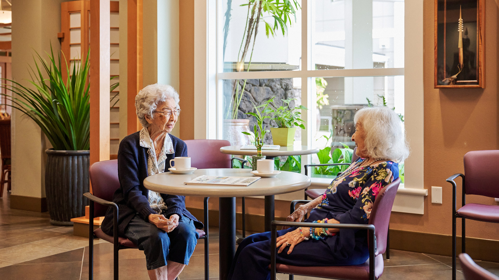 Residents talking over coffee at the plaza assisted living.