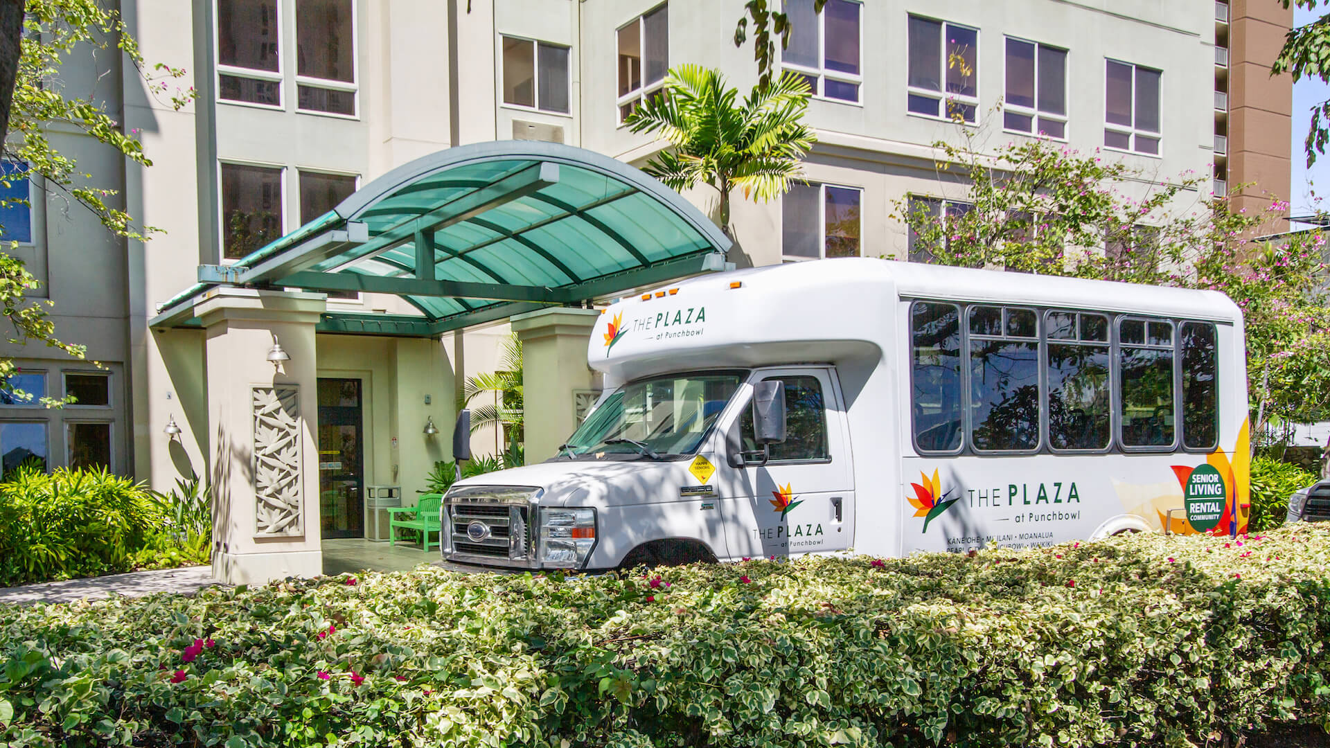 Exterior of The Plaza Assisted Living Punchbowl with resident shuttle bus.