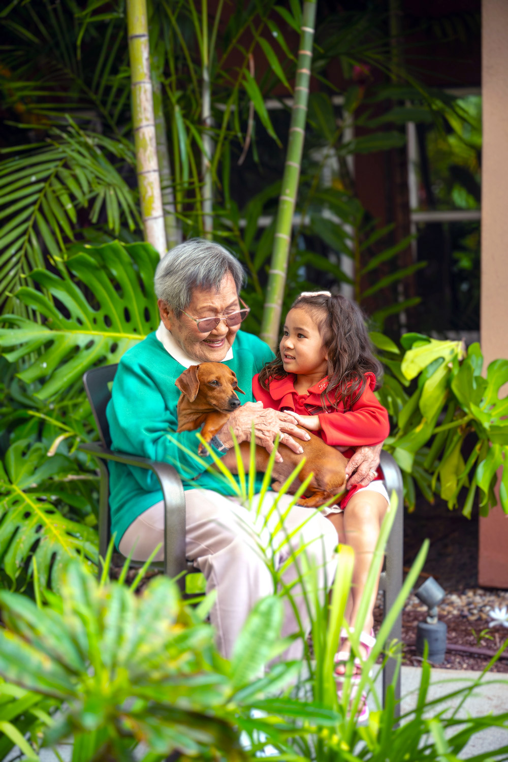 Resident with a child and dog in a pet friendly memory care community.