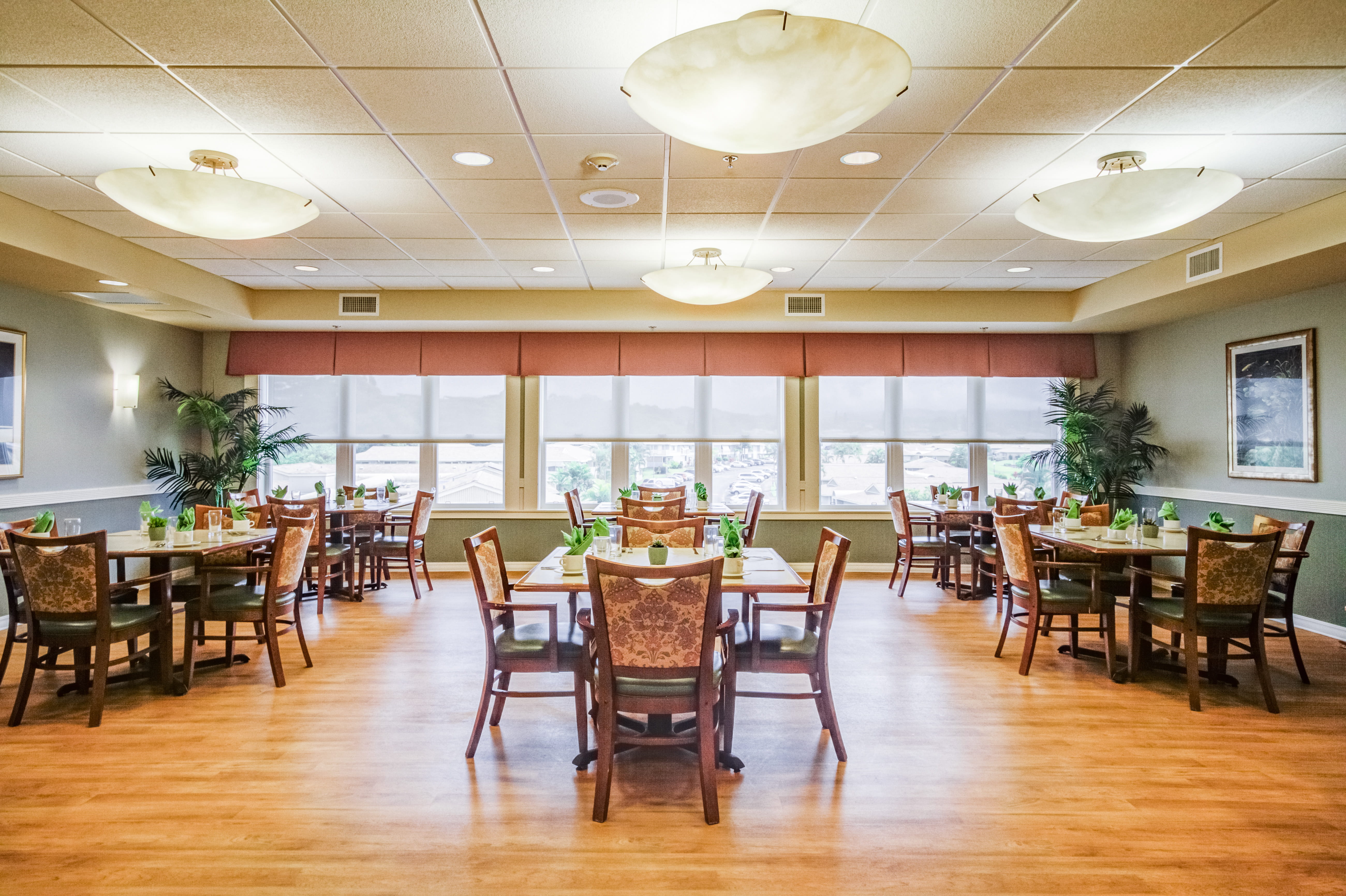 Bright dining room with mountain views at The Plaza Assisted Living Mililani.