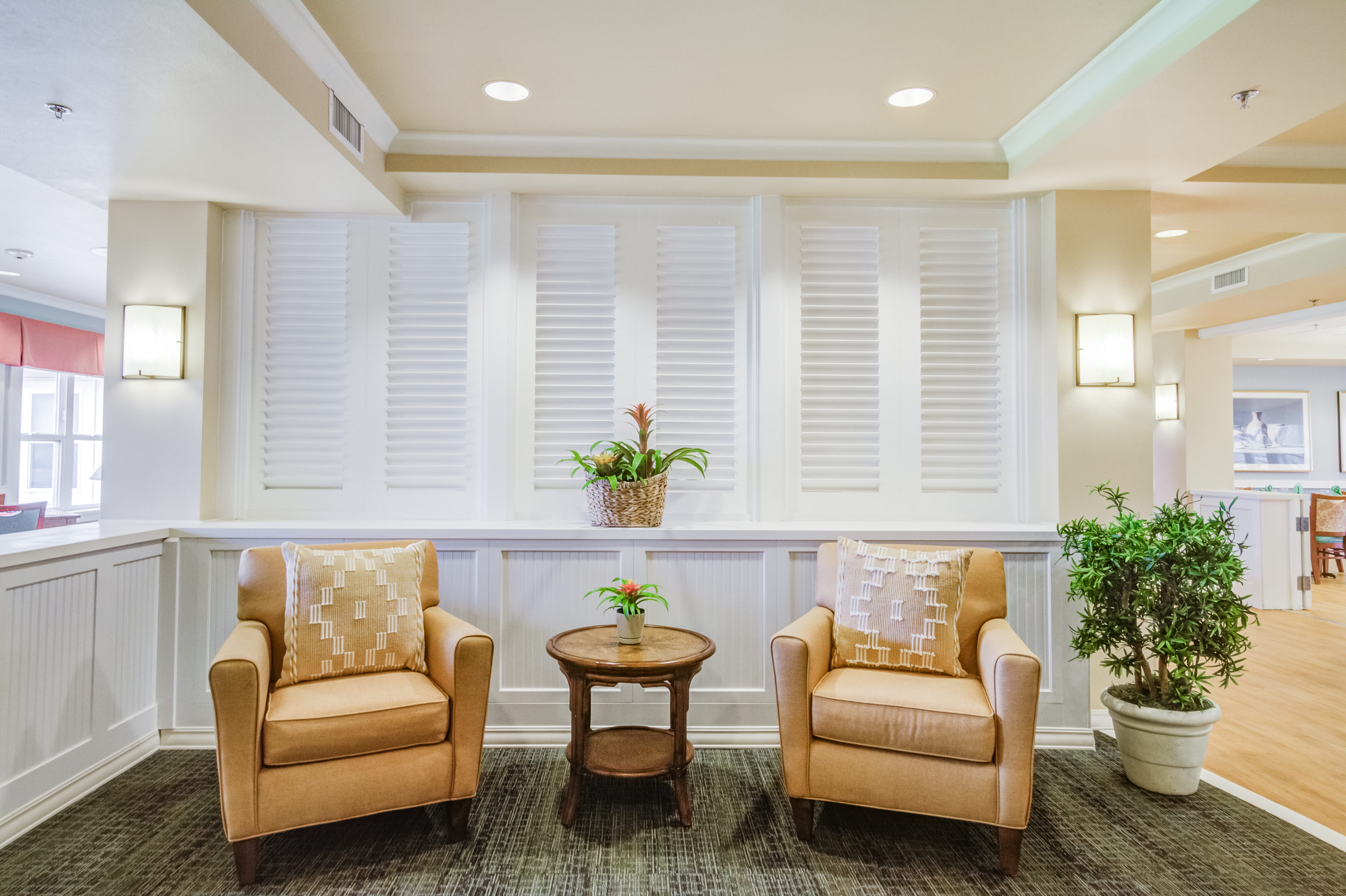 Quiet seating nook with two armchairs and a small table at a local senior living home.