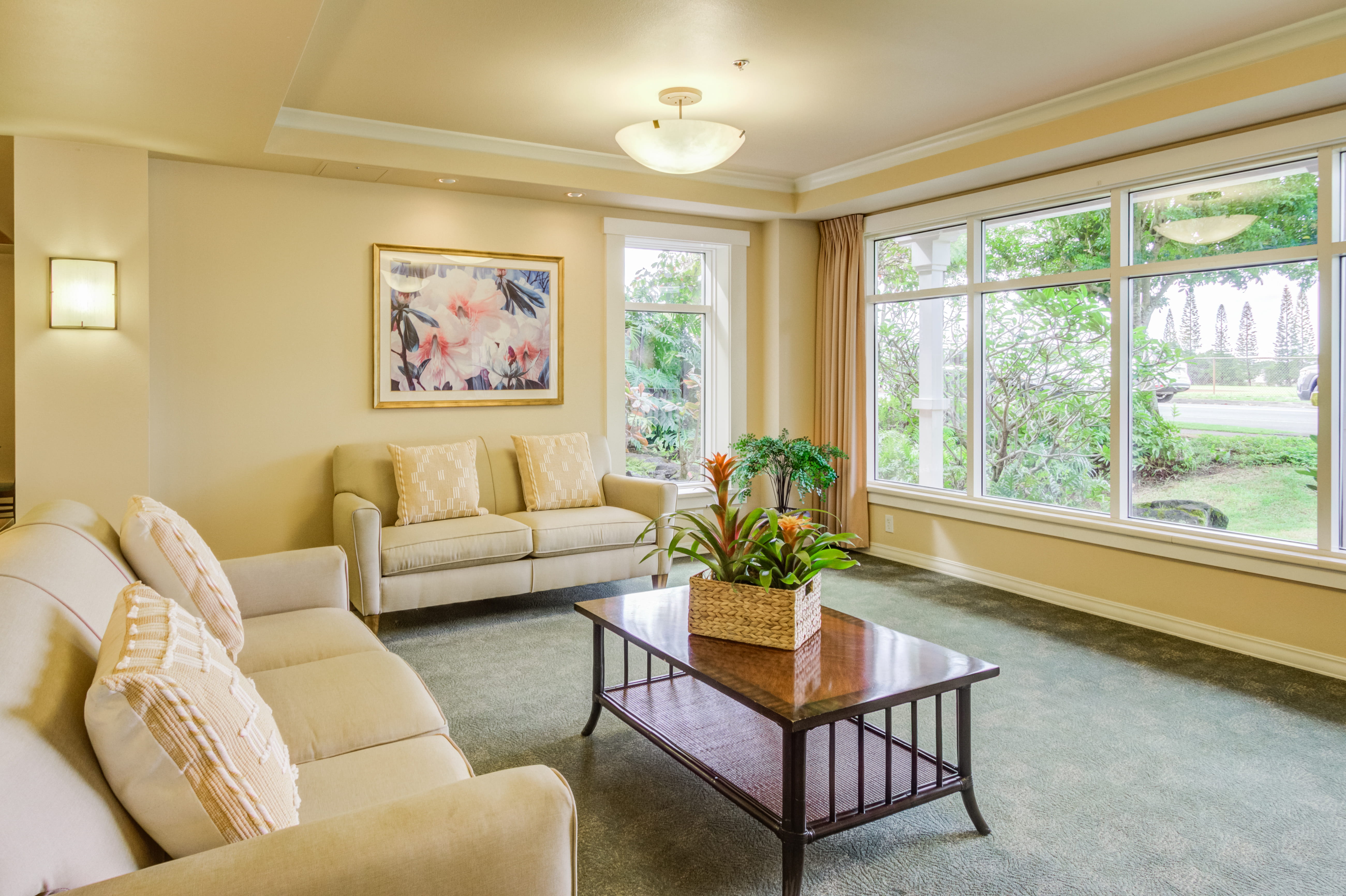 Bright sitting room with comfortable sofas at a local senior living facility.