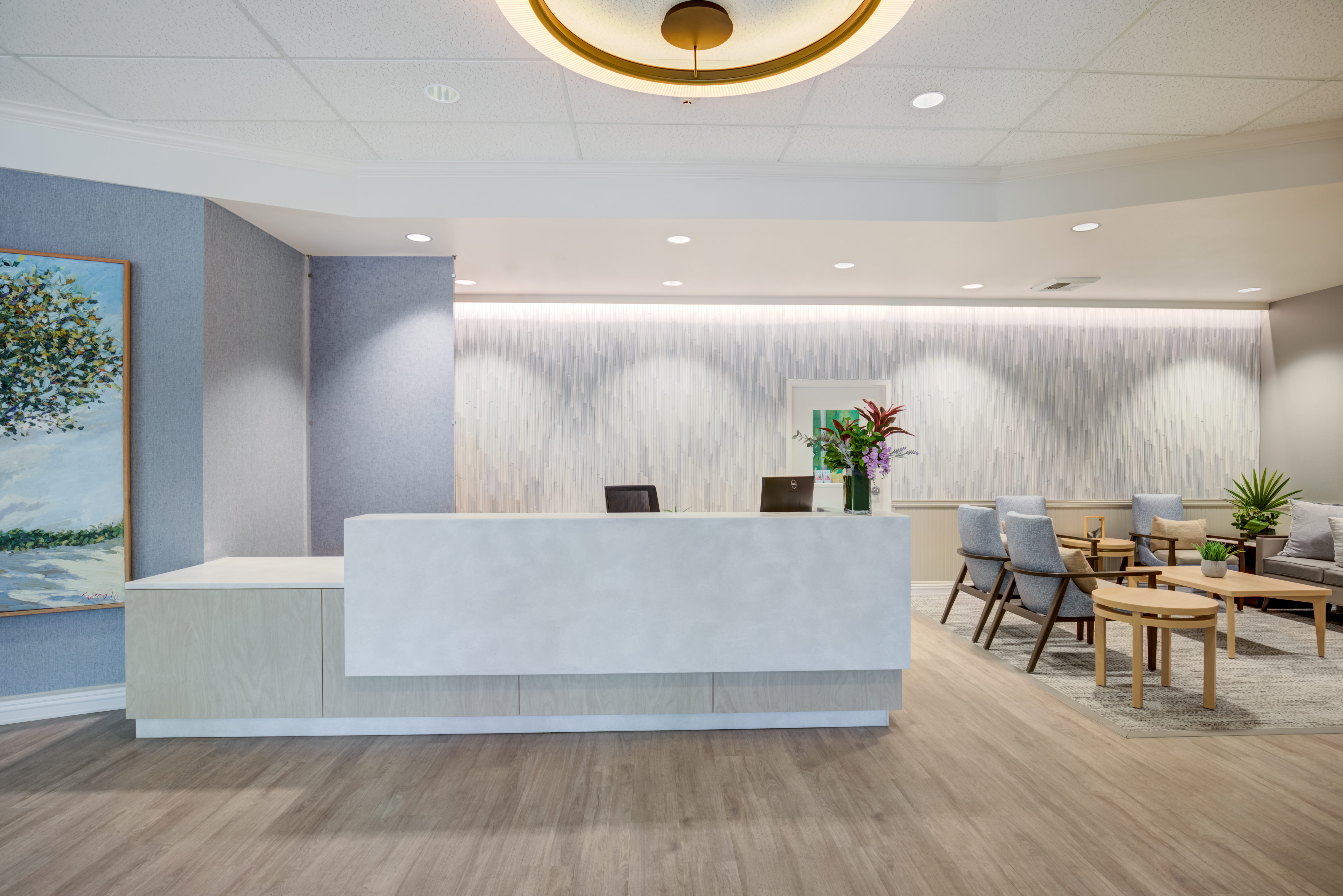 Modern white reception desk in the lobby of The Plaza Assisted Living.