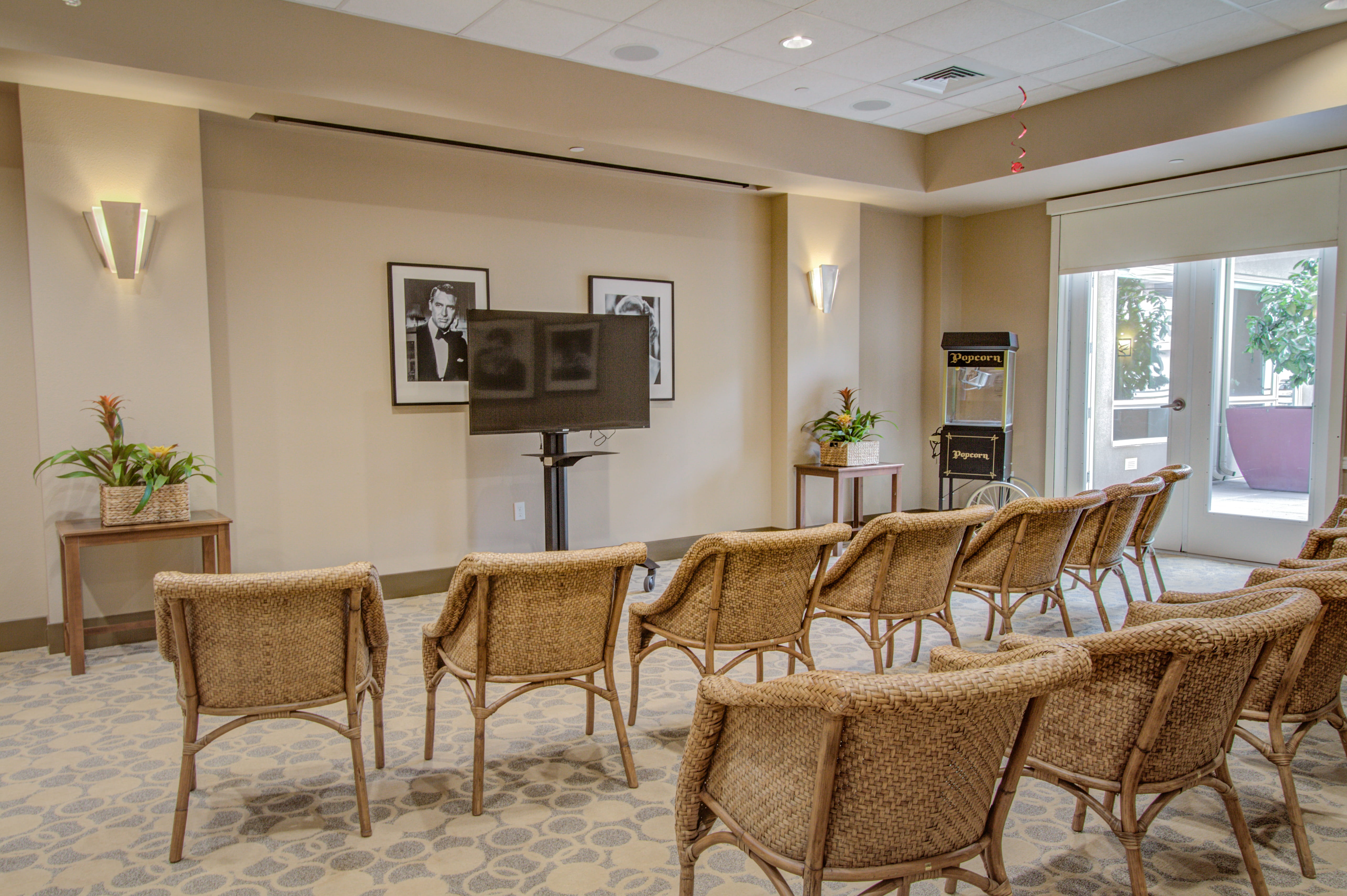 Resident movie theater room with wicker chairs at The Plaza at Waikiki.