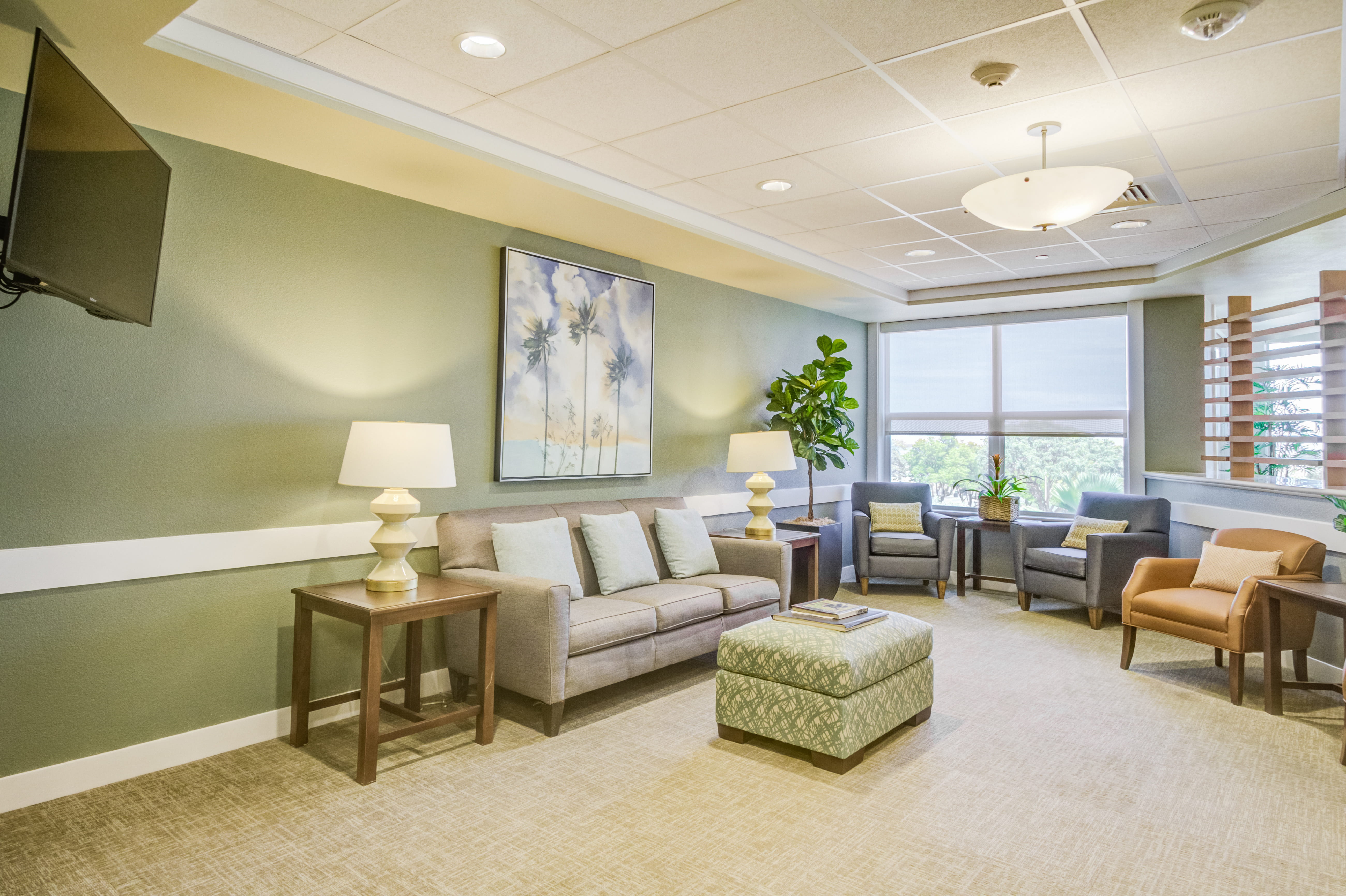 Modern television lounge and sitting area at The Plaza Assisted Living.